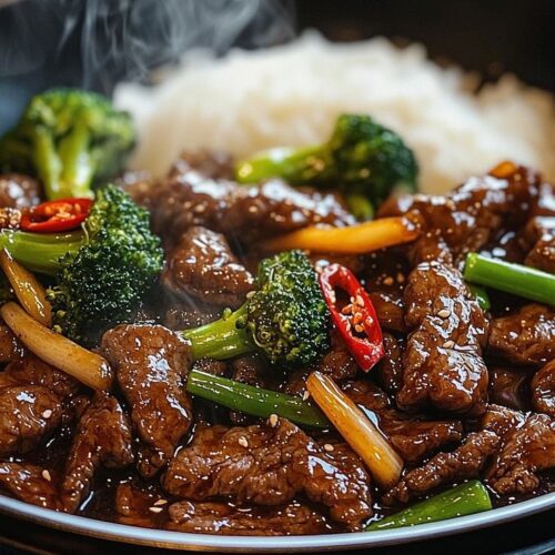 Beef in black bean sauce with broccoli and steamed Rice.