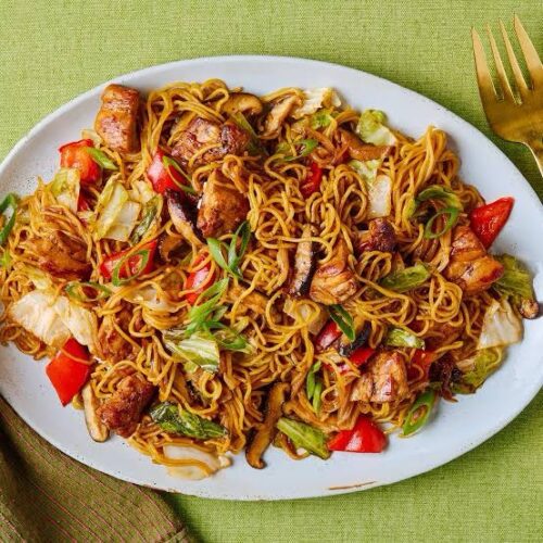 Special stir fry Nigerian noodles with chicken, sausage, assorted vegetables, and eggs