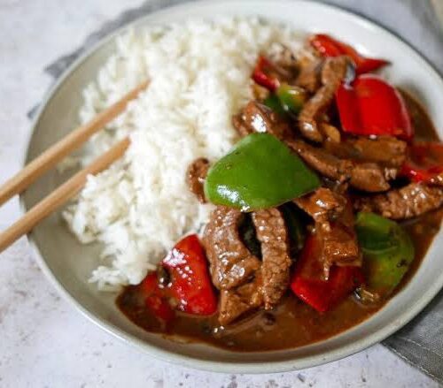 Beef in black bean sauce with broccoli and steamed Rice.